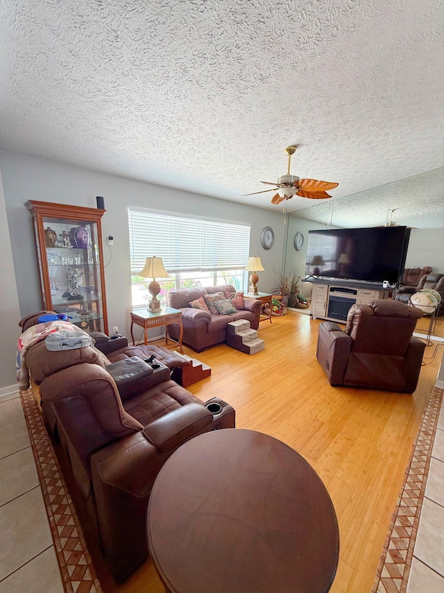 637 SW Sail Ter, Port Saint Lucie, FL 34953 - living room featuring a ceiling fan, a textured ceiling, and wood finished floors