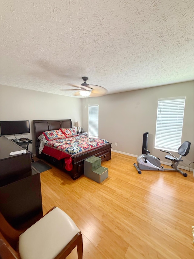 637 SW Sail Ter, Port Saint Lucie, FL 34953 - bedroom with a textured ceiling, light wood finished floors, ceiling fan, and an office area