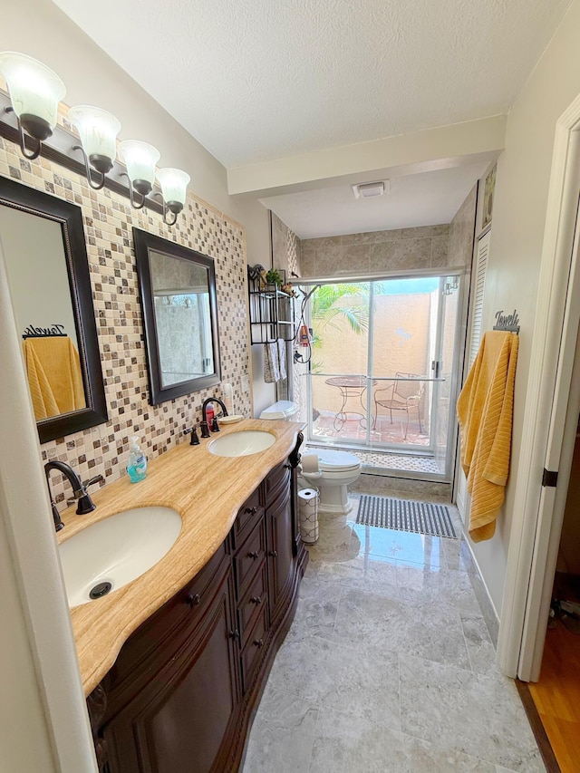 637 SW Sail Ter, Port Saint Lucie, FL 34953 - full bath featuring a shower with door, double vanity, and a textured ceiling
