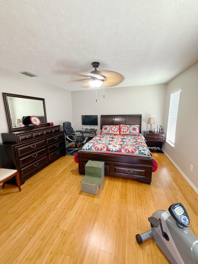 637 SW Sail Ter, Port Saint Lucie, FL 34953 - bedroom featuring light wood-style flooring, a textured ceiling, and ceiling fan