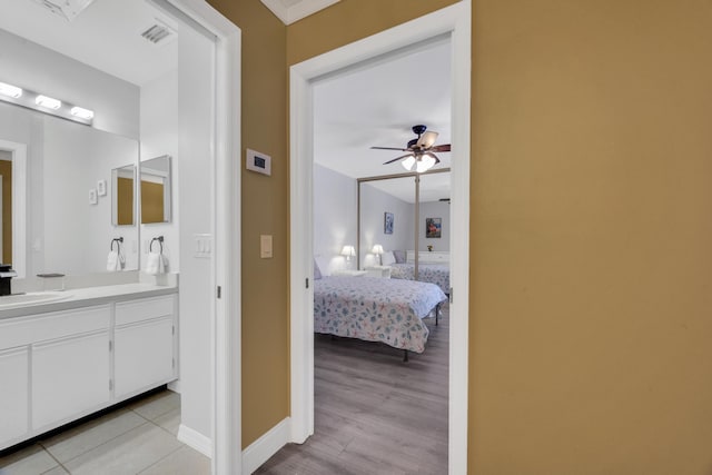 2004 SE Round Table Dr Unit 0, Port Saint Lucie, FL 34952 - bathroom featuring vanity, ceiling fan, ensuite bathroom, and wood finished floors