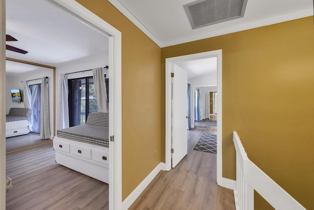 2004 SE Round Table Dr Unit 0, Port Saint Lucie, FL 34952 - hallway with light wood-style flooring and crown molding