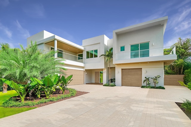 471 NW 9th St, Boca Raton, FL 33432 - modern home featuring a balcony, an attached garage, stucco siding, and decorative driveway