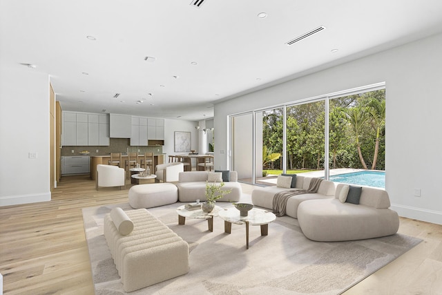 471 NW 9th St, Boca Raton, FL 33432 - living area featuring baseboards and light wood-type flooring