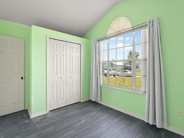 751 SE Majestic Ter, Port Saint Lucie, FL 34953 - unfurnished bedroom featuring vaulted ceiling, a closet, and dark wood-style flooring