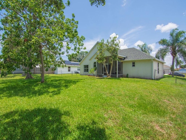 751 SE Majestic Ter, Port Saint Lucie, FL 34953 - back of house featuring a sunroom and a fenced backyard