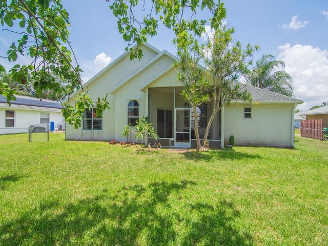 751 SE Majestic Ter, Port Saint Lucie, FL 34953 - rear view of property featuring a sunroom and stucco siding