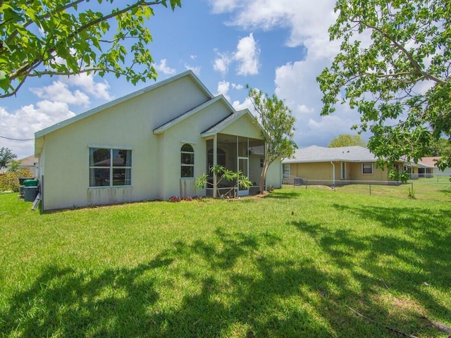 751 SE Majestic Ter, Port Saint Lucie, FL 34953 - rear view of property featuring a sunroom and stucco siding
