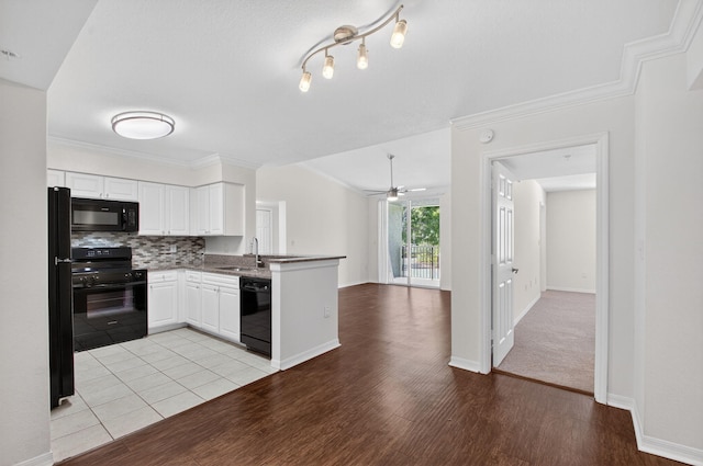 15185 Michelangelo Blvd Unit 207, Delray Beach, FL 33446 - kitchen featuring black appliances, a peninsula, white cabinetry, tasteful backsplash, and open floor plan