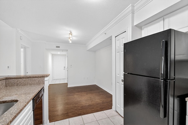 15185 Michelangelo Blvd Unit 207, Delray Beach, FL 33446 - kitchen with black appliances, light tile patterned flooring, crown molding, white cabinets, and light stone countertops