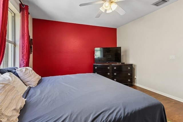 315 Spruce St, Boynton Beach, FL 33426 - bedroom with wood finished floors, an accent wall, and a ceiling fan