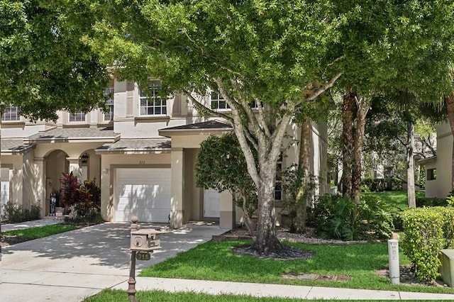 315 Spruce St, Boynton Beach, FL 33426 - view of front of property with an attached garage, stucco siding, concrete driveway, and a front lawn