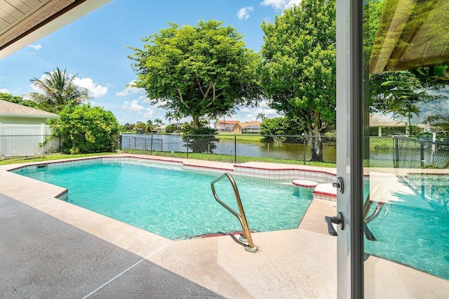 145 Waterway Rd, Royal Palm Beach, FL 33411 - view of swimming pool featuring a water view, a fenced backyard, and a patio
