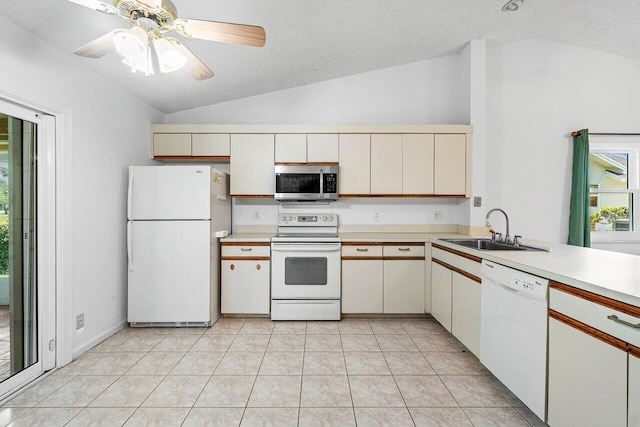145 Waterway Rd, Royal Palm Beach, FL 33411 - kitchen featuring white appliances, vaulted ceiling, light countertops, a textured ceiling, and light tile patterned flooring