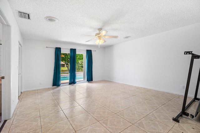 145 Waterway Rd, Royal Palm Beach, FL 33411 - empty room with a ceiling fan, a textured ceiling, and light tile patterned flooring