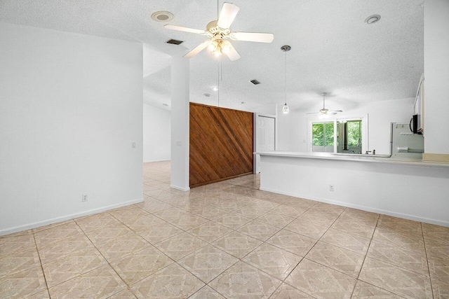 145 Waterway Rd, Royal Palm Beach, FL 33411 - empty room featuring ceiling fan, a textured ceiling, light tile patterned floors, wooden walls, and recessed lighting