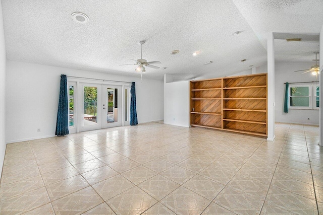 145 Waterway Rd, Royal Palm Beach, FL 33411 - empty room featuring a ceiling fan, french doors, a textured ceiling, light tile patterned floors, and built in features