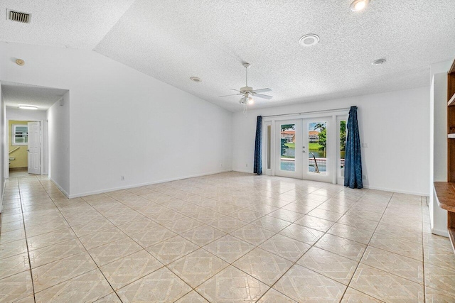 145 Waterway Rd, Royal Palm Beach, FL 33411 - spare room with a ceiling fan, a textured ceiling, light tile patterned floors, french doors, and lofted ceiling