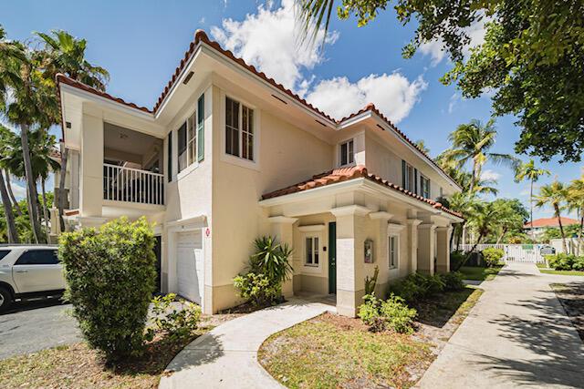 11765 W Atlantic Blvd Unit 1626, Coral Springs, FL 33071 - view of front of house with a tile roof, an attached garage, stucco siding, and a balcony