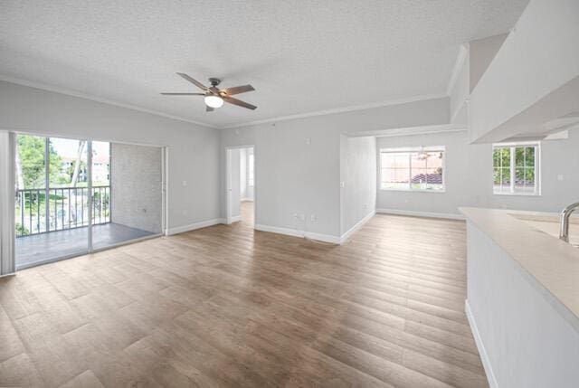 11765 W Atlantic Blvd Unit 1626, Coral Springs, FL 33071 - spare room featuring a ceiling fan, crown molding, a textured ceiling, and wood finished floors