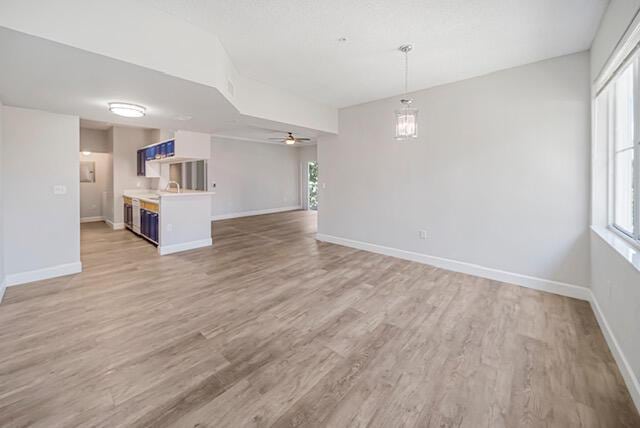 11765 W Atlantic Blvd Unit 1626, Coral Springs, FL 33071 - unfurnished living room featuring light wood-style floors and ceiling fan