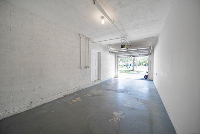 11765 W Atlantic Blvd Unit 1626, Coral Springs, FL 33071 - garage with concrete block wall and a garage door opener