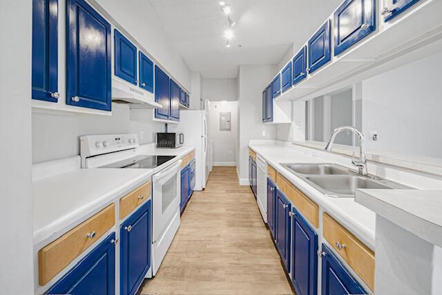 11765 W Atlantic Blvd Unit 1626, Coral Springs, FL 33071 - kitchen with white appliances, under cabinet range hood, blue cabinets, and light wood-style floors