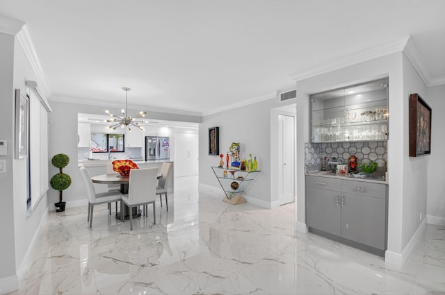 15822 Loch Maree Ln Unit 3203, Delray Beach, FL 33446 - dining room featuring a chandelier, ornamental molding, light marble finish floors, and wet bar