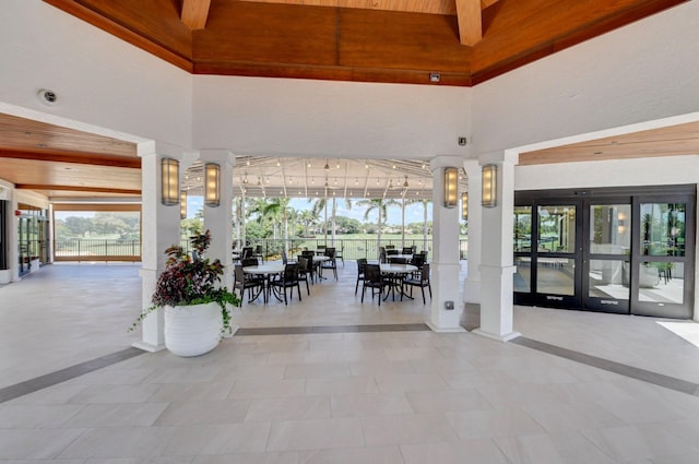 15822 Loch Maree Ln Unit 3203, Delray Beach, FL 33446 - building lobby featuring a high ceiling, wood ceiling, and a security system