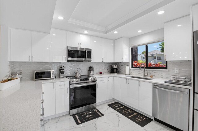 15822 Loch Maree Ln Unit 3203, Delray Beach, FL 33446 - kitchen with stainless steel appliances, recessed lighting, a raised ceiling, white cabinets, and light marble finish floors