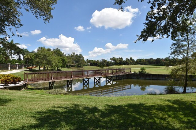 15822 Loch Maree Ln Unit 3203, Delray Beach, FL 33446 - dock area featuring a water view, a lawn, and view of wooded area