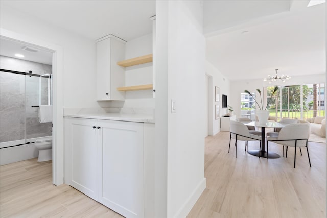 5189 Lake Catalina Dr Unit A, Boca Raton, FL 33496 - corridor featuring light wood finished floors and a chandelier
