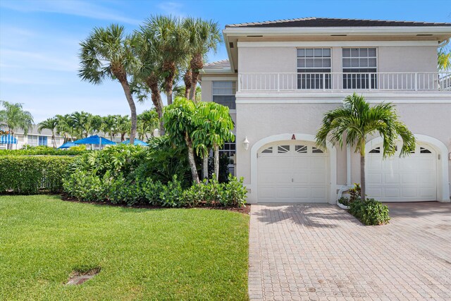 5189 Lake Catalina Dr Unit A, Boca Raton, FL 33496 - view of front of home featuring stucco siding, decorative driveway, a front yard, and a garage