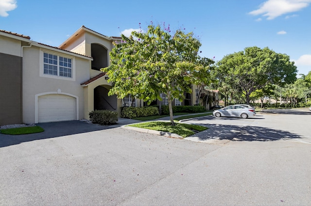 15155 Michelangelo Blvd Unit 103, Delray Beach, FL 33446 - multi unit property with stucco siding, asphalt driveway, and a garage