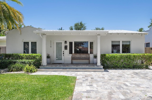 1116 SE 11th St, Fort Lauderdale, FL 33316 - view of front of house featuring stucco siding, a porch, and a front yard