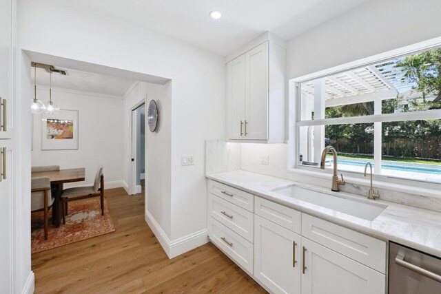 1116 SE 11th St, Fort Lauderdale, FL 33316 - kitchen featuring dishwasher, plenty of natural light, light wood-style floors, white cabinetry, and recessed lighting