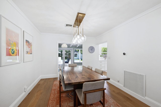 1116 SE 11th St, Fort Lauderdale, FL 33316 - dining area featuring wood finished floors, ornamental molding, and a chandelier