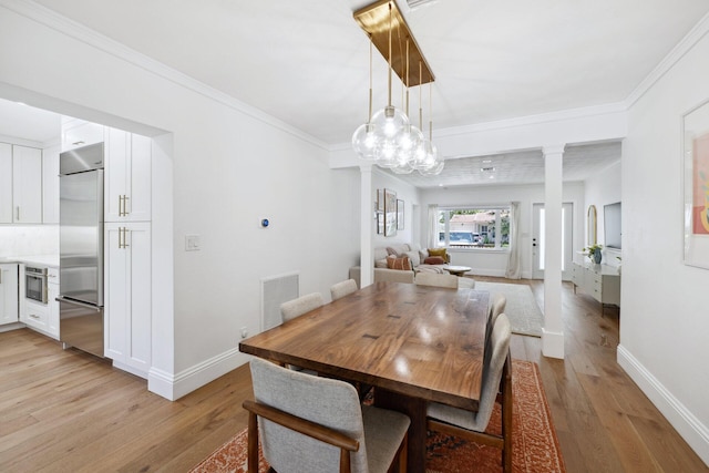 1116 SE 11th St, Fort Lauderdale, FL 33316 - dining room with decorative columns, light wood-style floors, crown molding, and a chandelier