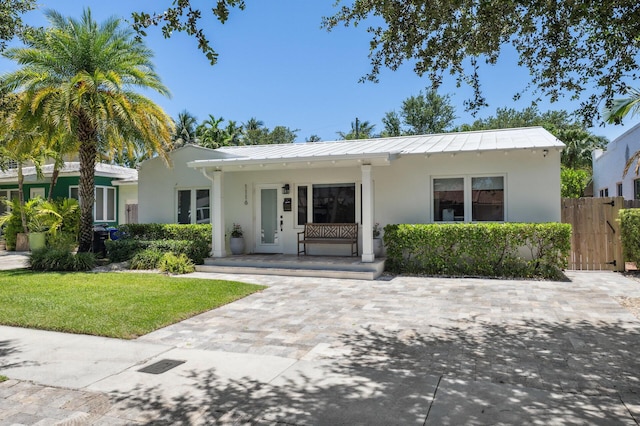 1116 SE 11th St, Fort Lauderdale, FL 33316 - view of front facade featuring a standing seam roof, covered porch, and stucco siding