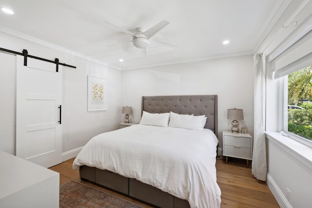 1116 SE 11th St, Fort Lauderdale, FL 33316 - bedroom with crown molding, a barn door, recessed lighting, wood finished floors, and ceiling fan