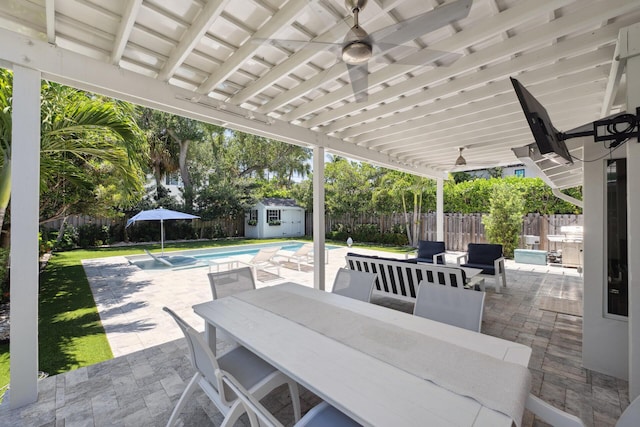 1116 SE 11th St, Fort Lauderdale, FL 33316 - fenced backyard with outdoor dining space, a patio, ceiling fan, and a storage unit