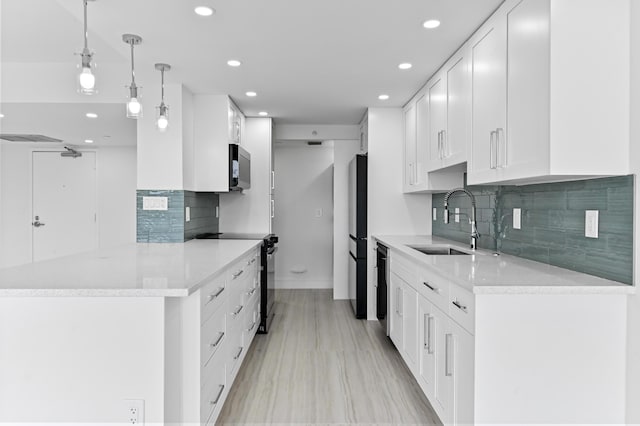 899 Jeffery St Unit 208, Boca Raton, FL 33487 - kitchen with black electric range oven, recessed lighting, backsplash, white cabinetry, and freestanding refrigerator