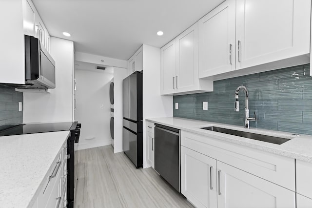 899 Jeffery St Unit 208, Boca Raton, FL 33487 - kitchen featuring stainless steel appliances, white cabinets, recessed lighting, light stone counters, and backsplash