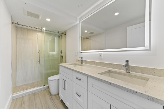 899 Jeffery St Unit 208, Boca Raton, FL 33487 - full bathroom featuring double vanity, a stall shower, recessed lighting, and wood finished floors