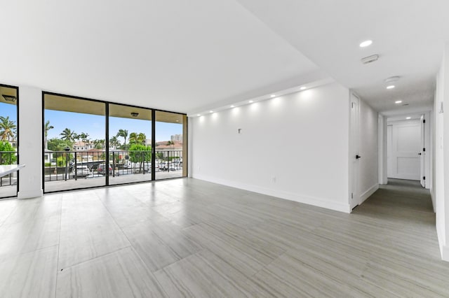 899 Jeffery St Unit 208, Boca Raton, FL 33487 - unfurnished room with floor to ceiling windows, a smoke detector, and recessed lighting
