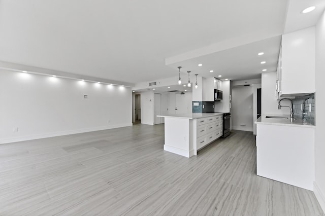 899 Jeffery St Unit 208, Boca Raton, FL 33487 - kitchen with range with electric cooktop, open floor plan, light countertops, white cabinetry, and recessed lighting