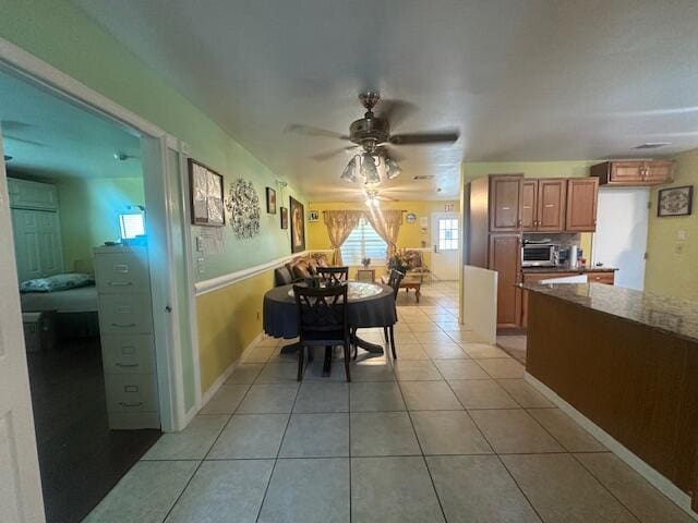 1910 SE Rainier Rd, Port Saint Lucie, FL 34952 - dining area with a ceiling fan and light tile patterned floors