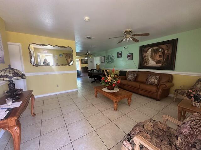 1910 SE Rainier Rd, Port Saint Lucie, FL 34952 - living area featuring a ceiling fan and light tile patterned flooring