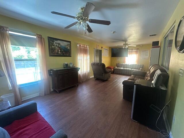 1910 SE Rainier Rd, Port Saint Lucie, FL 34952 - living room with wood finished floors and a ceiling fan