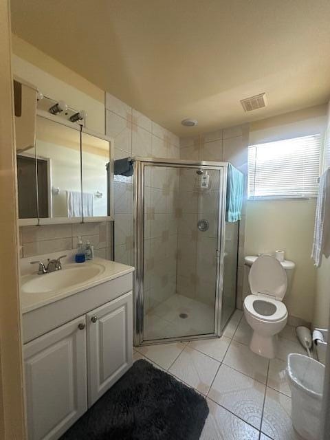 1910 SE Rainier Rd, Port Saint Lucie, FL 34952 - full bathroom featuring vanity, a stall shower, and tile patterned floors